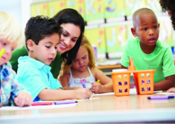 Kids Kare teacher supporting children in a classroom